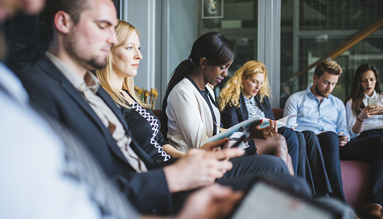 Group of Candidates in Waiting Room. Stay Motivated During Security Job Market Fluctuations.